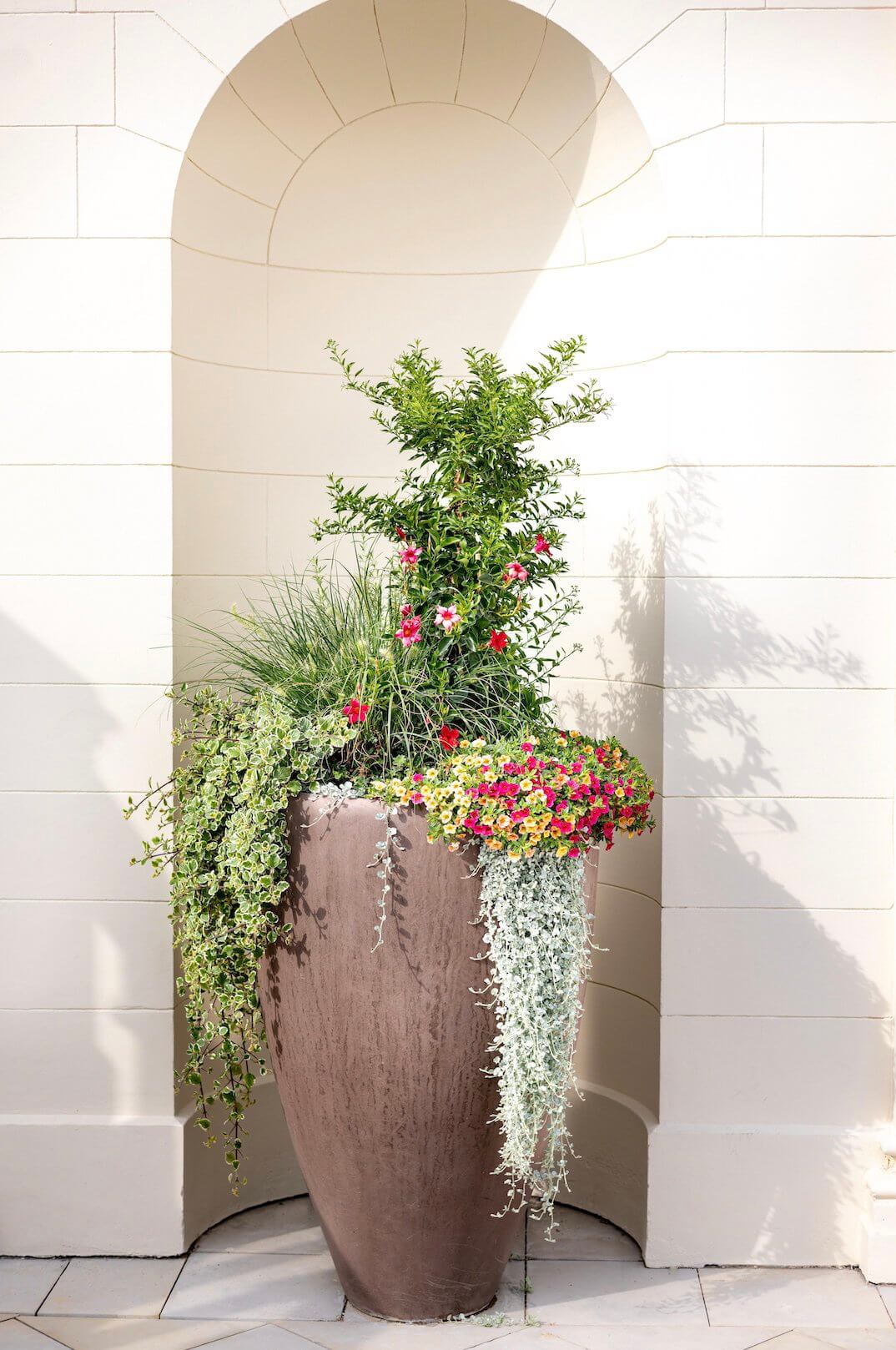 faux plants in a tall planter 