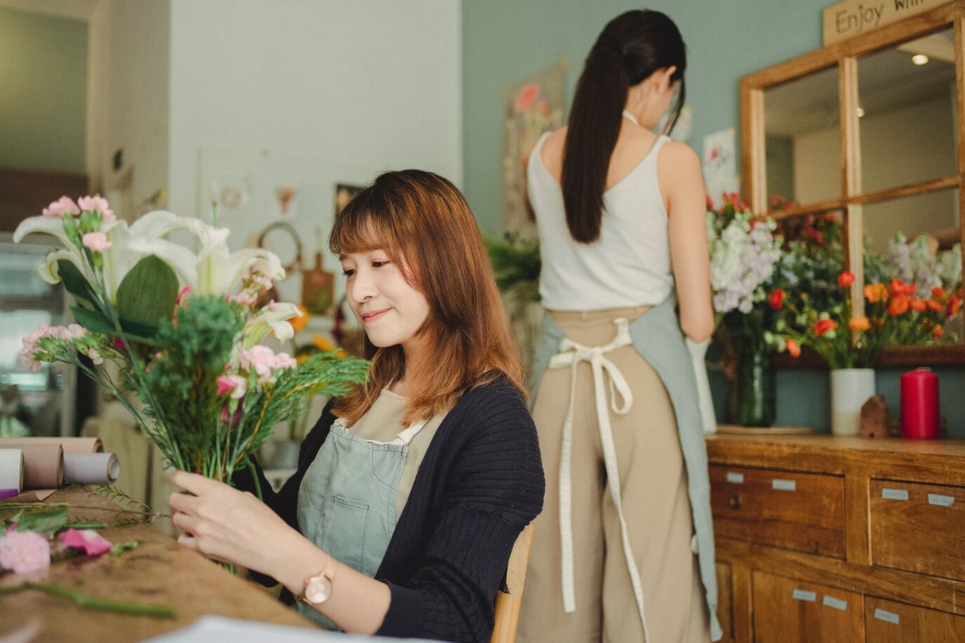 two florists arranging artificial flowers