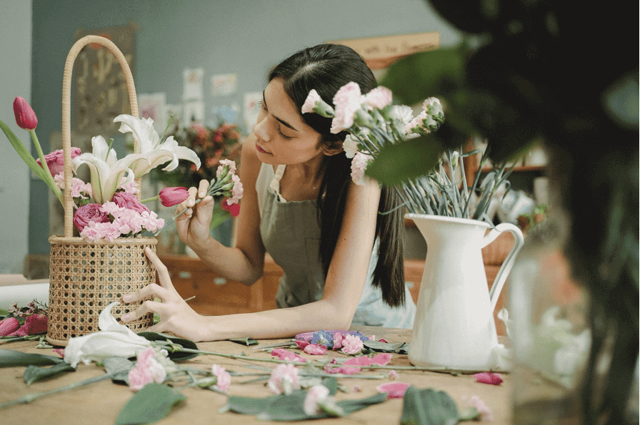 Florist arranging flowers in a basket