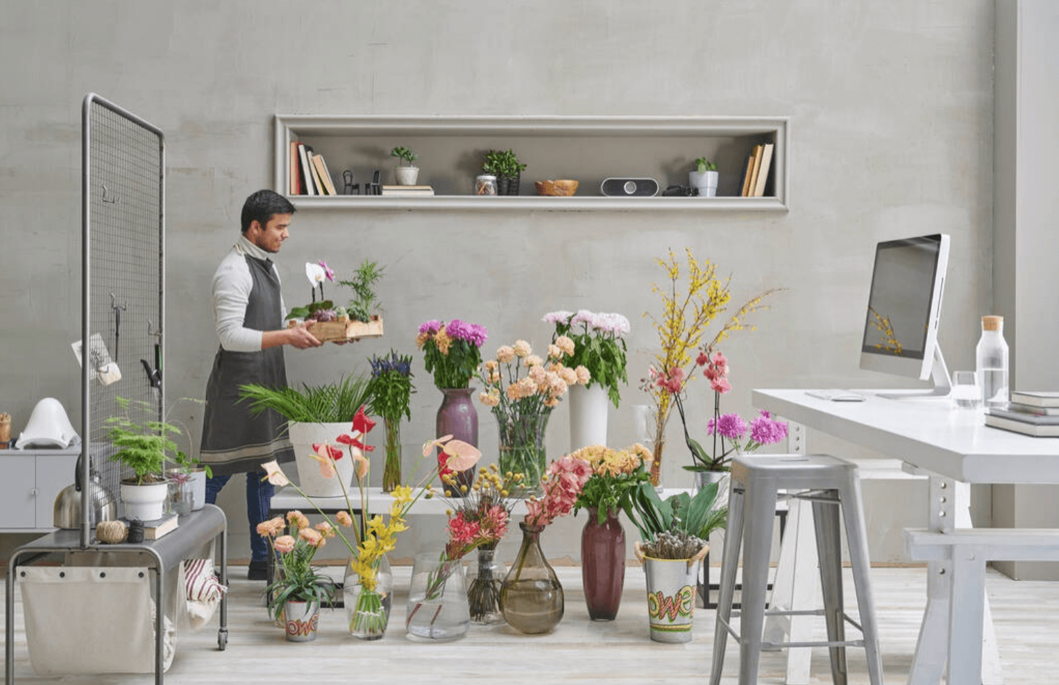 man working with flowers in vases