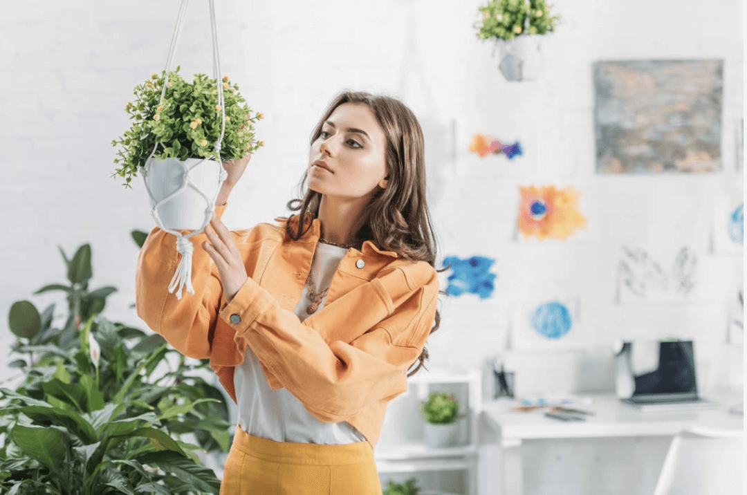 woman installing a hanging plant