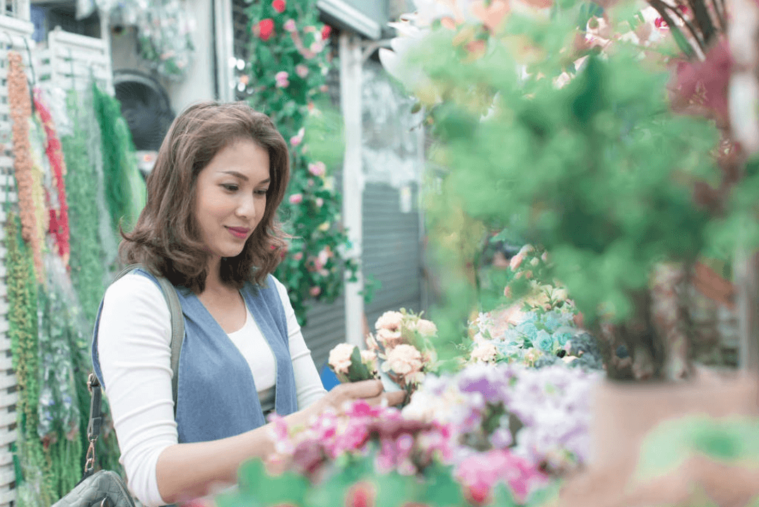 woman arranging artificial flowers